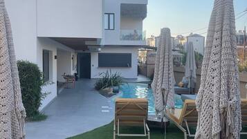 Seasonal outdoor pool, open 9:00 AM to 9:00 PM, pool umbrellas