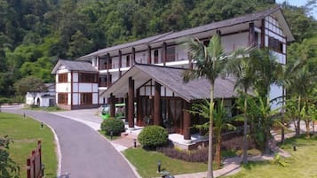 A two-story building with a traditional architectural style, featuring a balcony on the upper floor.