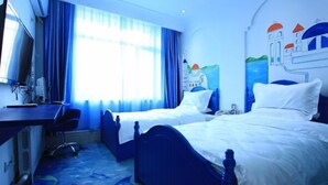 A hotel room with two beds, a desk with a chair, a TV, and a large window with blue curtains. - Xintian'e Boutique Hotel (Ulanhot)