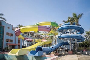 A water park with multiple water slides in various colors. - Xinsha Hotel (Zhanjiang)