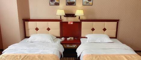 A hotel room with two beds, a wooden headboard, a nightstand, and three wall-mounted lamps.