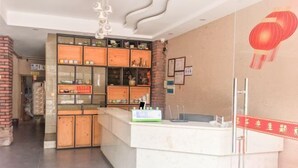 A modern interior with a reception desk, a brick wall, and a decorative lantern. - Danzhou xillelai theme travel rental (Danzhou)