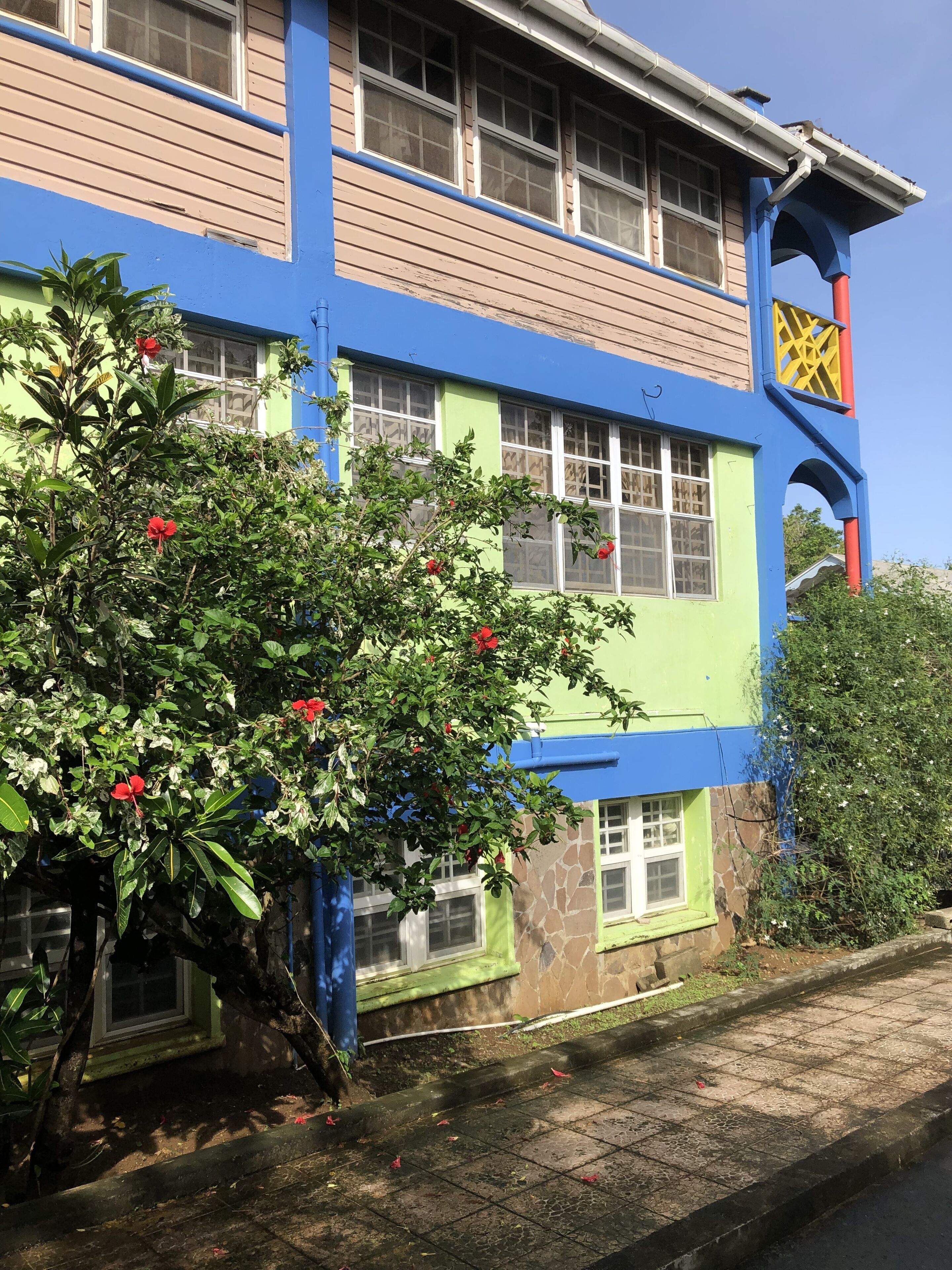 A colorful building with multiple windows and a staircase.