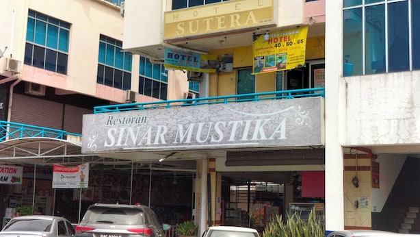 A building with a sign for 'Hotel Sutera' and 'Restoran Sinarmustika'.
