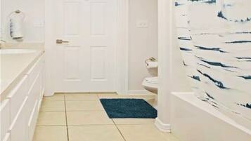 Bathtub, hair dryer, towels, soap