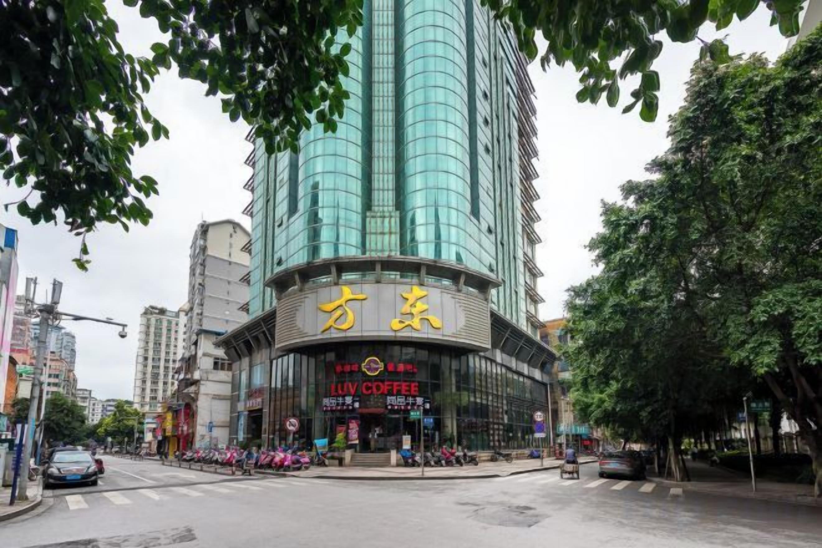 A multi-story building with a prominent sign for 'LIV COFFEE' and Chinese characters.