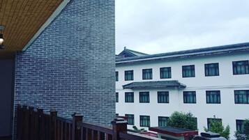 A building with a traditional architectural style, featuring a tiled roof and multiple windows.