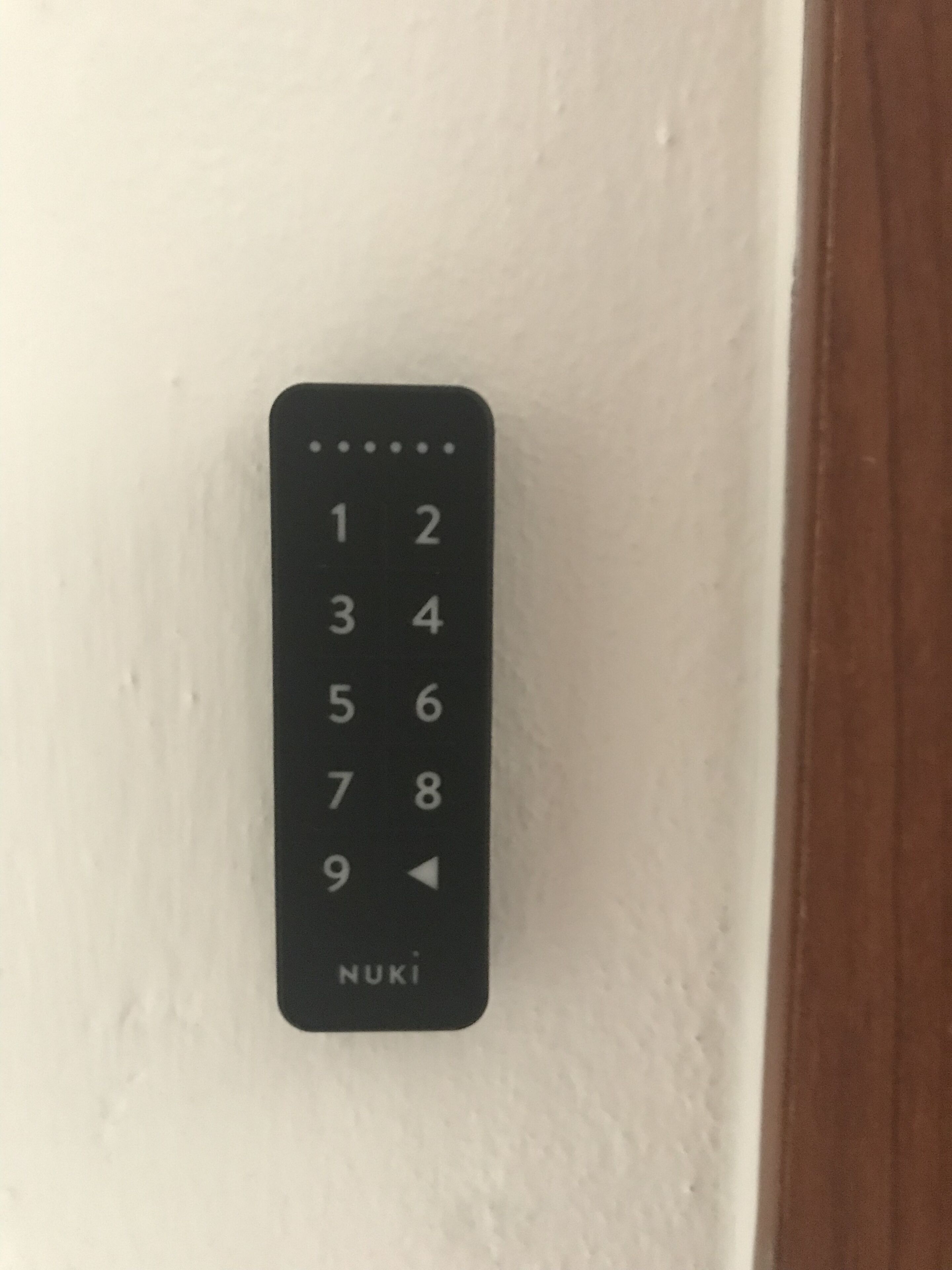 A black numeric keypad with the brand name "NUKI" on a white wall.