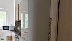 A modern kitchen with a built-in oven, microwave, and sink.
