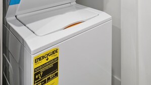 A front-loading washing machine with an ENERGYGUIDE sticker, control panel, and a door. - Miami Suite 303 (Miami)