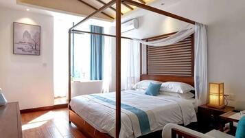 A four-poster bed with a wooden frame, a bedside table with a lamp, and a wall-mounted air conditioner.