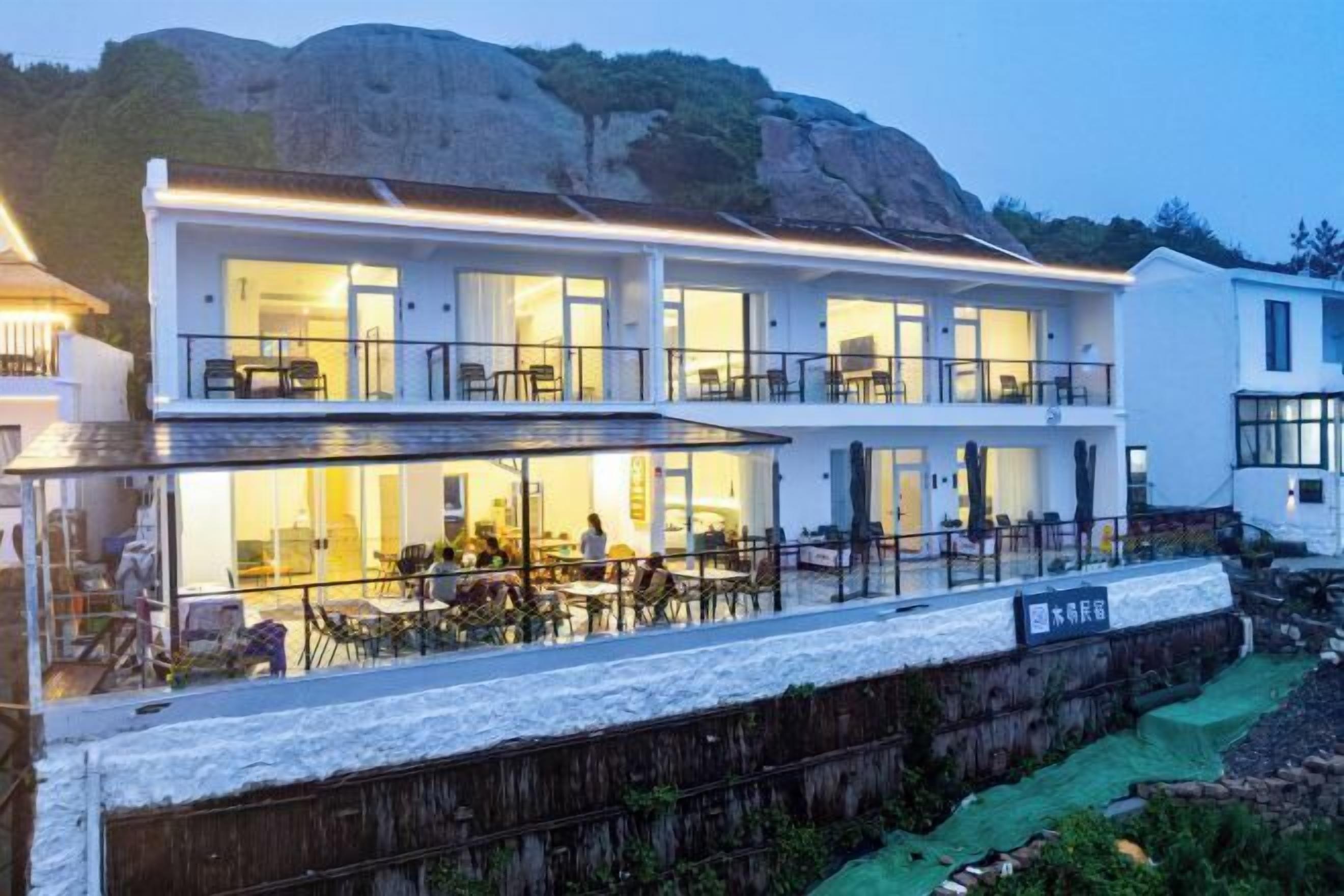 A two-story building with a dining area on the ground floor and a bar/lounge on the upper floor.