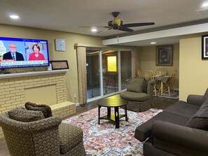 Relax in style with a flat-screen TV, brick fireplace, and comfortable seating area.