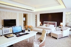 A hotel room with a bed, a desk with a TV, a chair, and a bedside table. - International Academic Exchange Center (Yuntang Campus Hotel, CSUST) (Changsha)