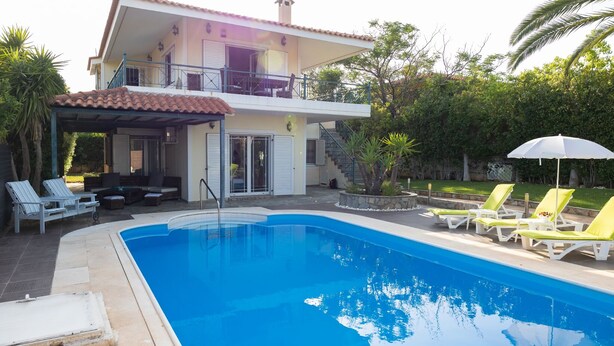 A two-story house with a swimming pool, outdoor seating, and a covered patio area. - Villa Rose (Anavissos)