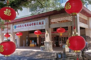 A traditional Chinese building with red lanterns hanging outside. - Yichun Jing'an · Changlv Qinlu Jiuling Hot Spring Hotel (Kuangzhong Garden) (Jing'an)