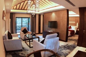 A modern hotel room with a large TV, comfortable seating, a chandelier, and a view of the outdoors. - Yichun Jing'an · Changlv Qinlu Jiuling Hot Spring Hotel (Kuangzhong Garden) (Jing'an)