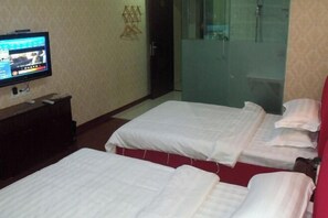 A hotel room with two beds, a TV on the wall, and a glass shower door. - Chaohu Jiangnan Hotel (Chaohu)