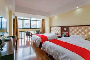 A hotel room with two beds, a desk, and a view of the city. - Hande Hotel (Baise)