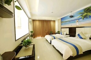 A hotel room with a bed, a desk, a chair, a TV, and a window with curtains. - Ledong Fuhua Haoting Hotel (Huangliu Branch) (Ledong)