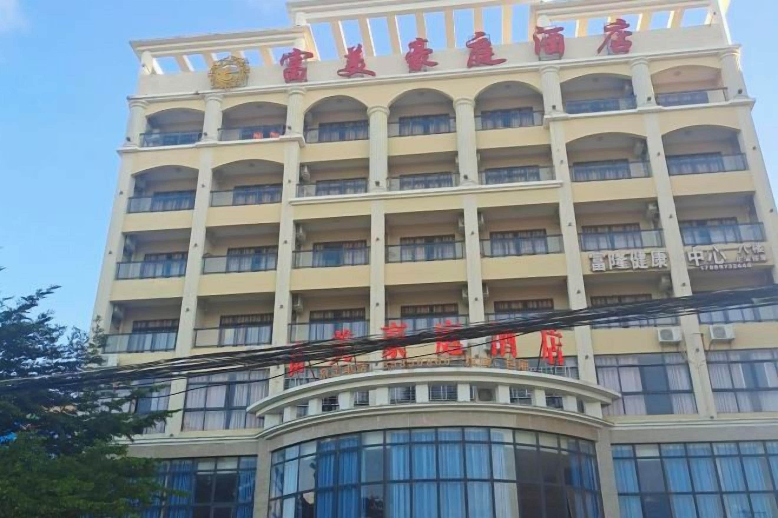 A multi-story hotel with a prominent red sign at the top.