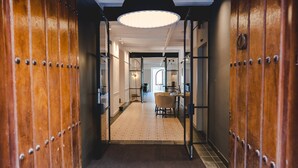 A hallway with wooden doors, a dining area, and a kitchen in the background. - ORA Hotel Priorat, a Member of Design Hotels (Torroja del Priorat)