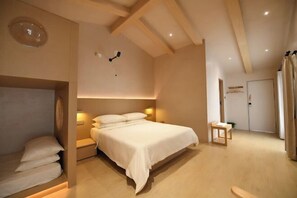 A bedroom with a bed, bedside tables, a small stool, and a door. - Lost&Found@Wutong House (Shenzhen)