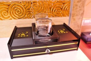 A black box with a clear glass container on top, a lockable compartment, and a logo with Chinese characters. - Xingdu Hotel (Fangchenggang)
