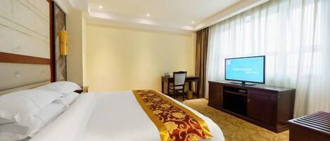 A hotel room with a bed, a television, a desk, and a chair.
