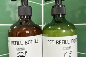 Two refill bottles labeled 'PET REFILL BOTTLE' with a 'LOTION' icon. - V-Hostel (Dali City)