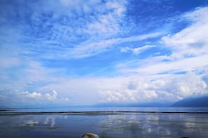 A calm body of water with a clear sky and distant land. - Shanshui Qingju Inn (Dali City)