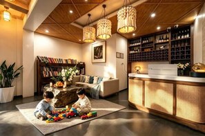 A cozy living room with a fireplace, a bookshelf, and a coffee table. - Shanshui Qingju Inn (Dali City)