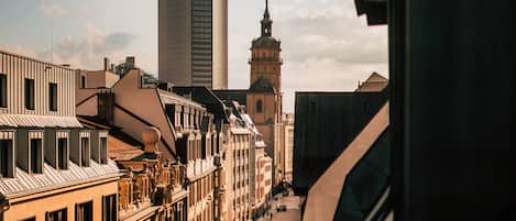A cityscape with historic buildings and a modern skyscraper.