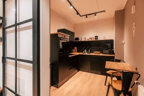 *Metropolitan* 1-Room Apartment with Kitchen | Private kitchen | Cleaning supplies, dining tables