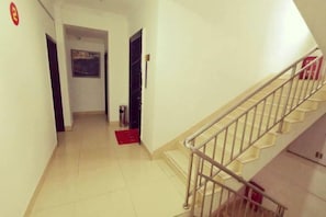 Staircase leads to a door from a simple corridor.