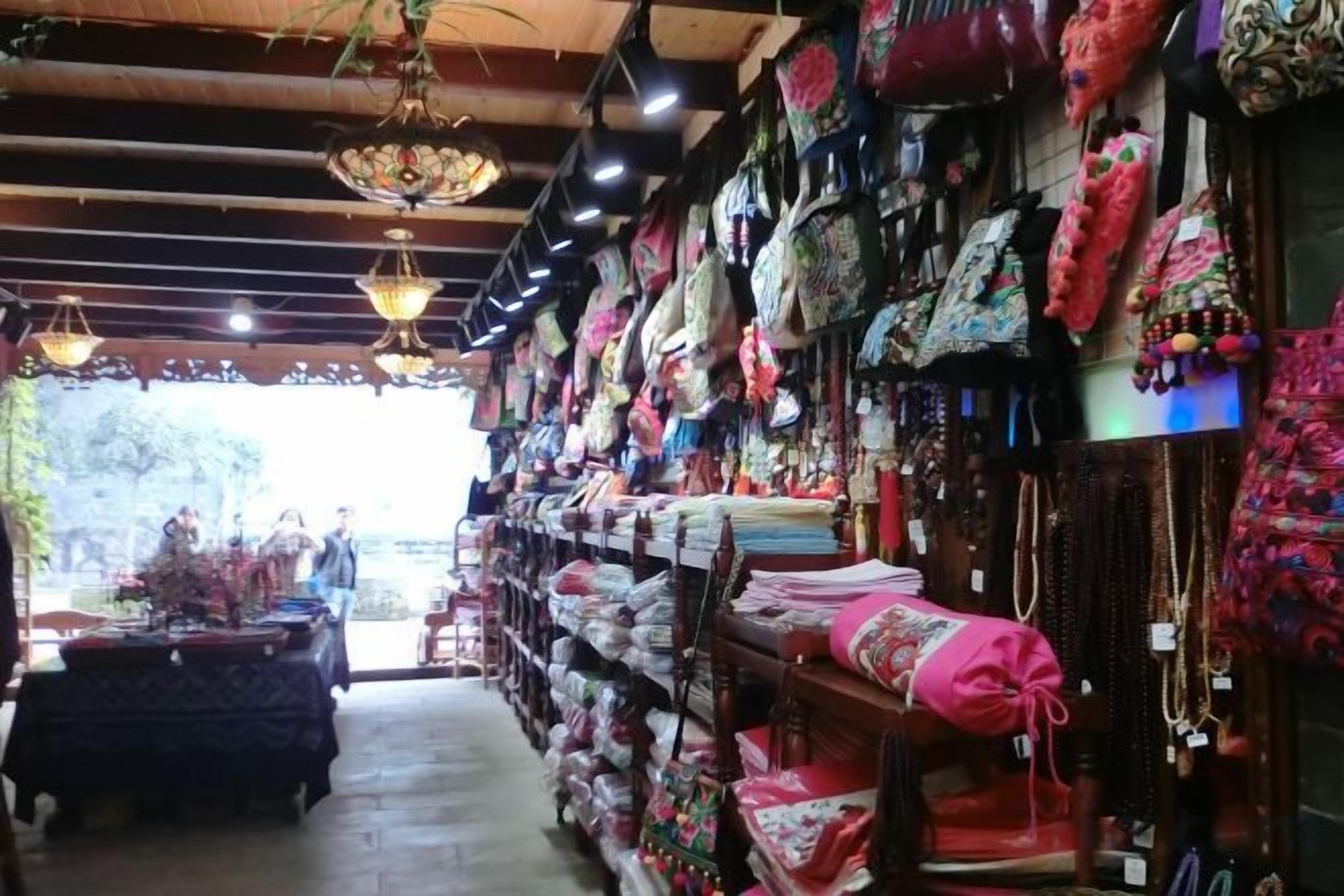 A store with shelves of colorful textiles and hanging items.