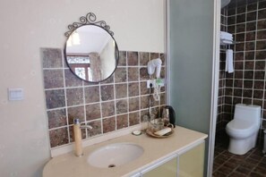 A bathroom with a sink, mirror, and tiled walls. - Dongshan Courtyard Inn (Chengdu)