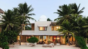 A beachfront property with a two-story building, a covered patio, and a pool. - Villa Blanca, Tulum – Beachfront • Chef Included (Tulum)