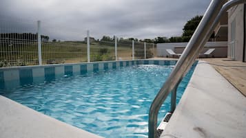 Seasonal outdoor pool, open 9:00 AM to 8:00 PM, pool loungers