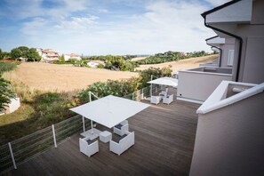 Enjoy dining or socializing on the deck, surrounded by lush greenery and countryside views.