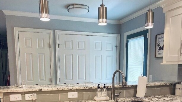 A kitchen with white cabinets, stainless steel appliances, a double sink, and pendant lighting. - Adversity Home - Open Concept, with Pacman Machine. Close to I-40 Airport (Amarillo)