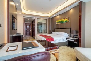 A hotel room with a bed, bedside table, lamp, and a view of the hallway. - Jinhengsheng Holiday Hotel (Yunxiao)