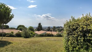 A residential area with houses, a grassy field, and a clear sky. - N256 - Numana, brand new three-room apartment with garden (Sirolo)