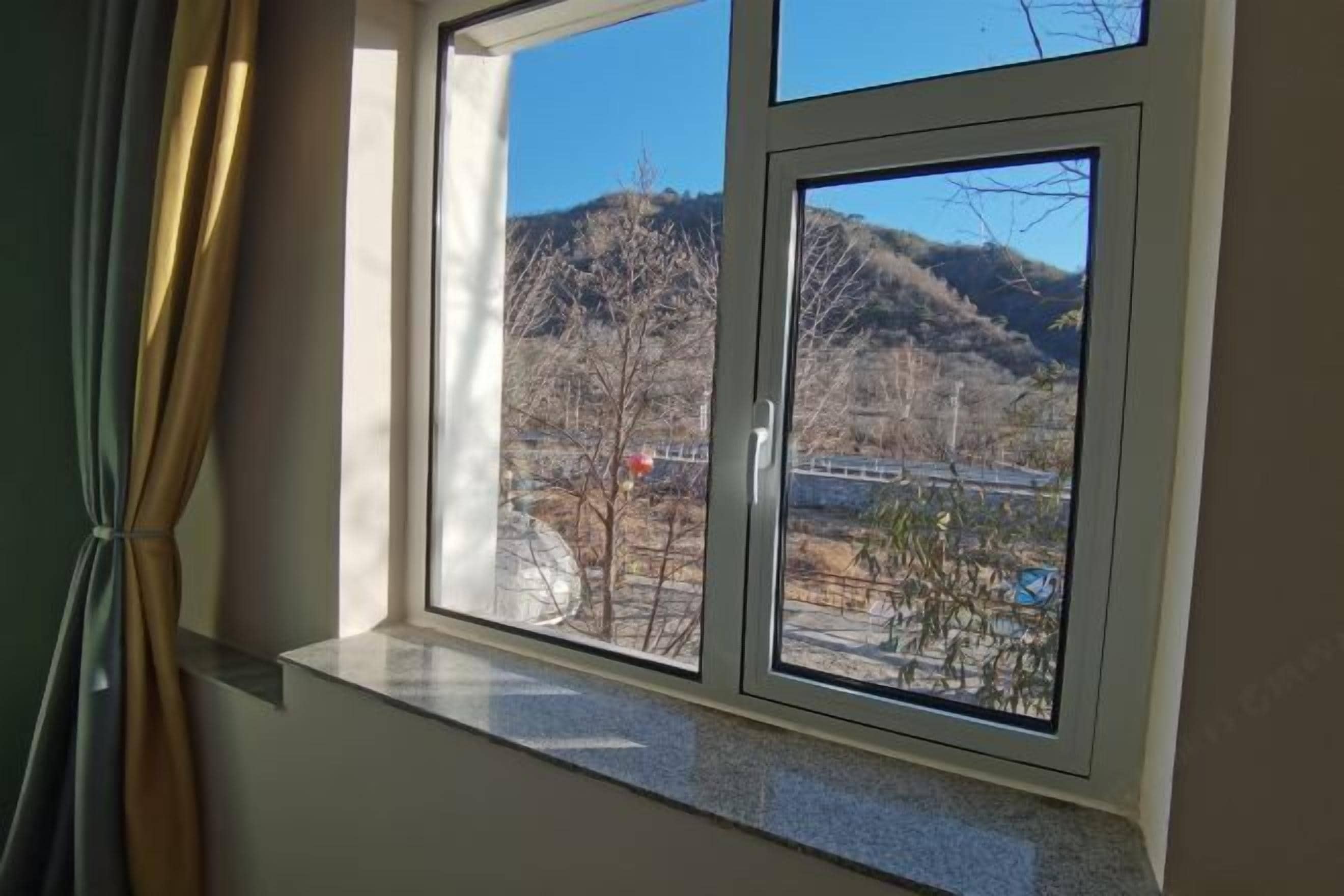 A window with a view of a mountainous landscape.