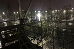 A nighttime view of a construction site with metal scaffolding and bare trees. - Shanyushui Post Inn (Nantong)