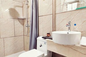 A bathroom with a white sink, a shower, and a toilet. - Shanyushui Post Inn (Nantong)