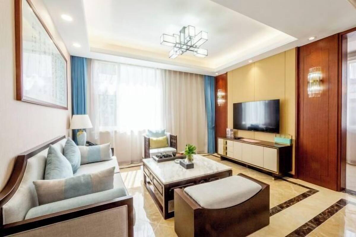 A modern living room with a sofa, coffee table, and TV.