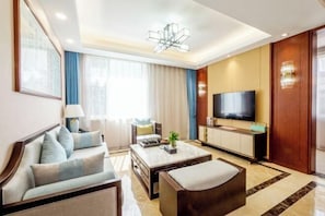 A modern living room with a sofa, coffee table, and TV.