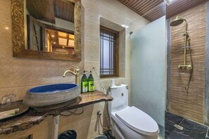 A bathroom with a marble sink, a toilet, and a shower. - NAXI yage hotel (Lijiang)