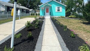 A turquoise house with a red door, a white picket fence, and a pathway leading to it. - NEW LISTING!!!  Villas Quaint Coastal Cottage short drive to Beaches (Lower Township)